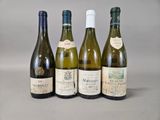 four bottles of wine are lined up on a table
