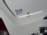 a sticker on the back of a white car