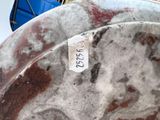 a close up of a metal plate with a tag on it
