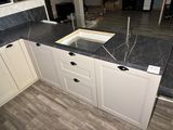 a kitchen counter with a sink and a window in it
