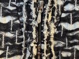 a close up of a black and white jacket with a zipper