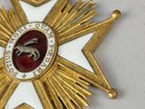 gold star with a purple ribbon and a purple ribbon around it