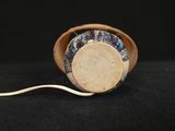 a small wooden object with a cord attached to it