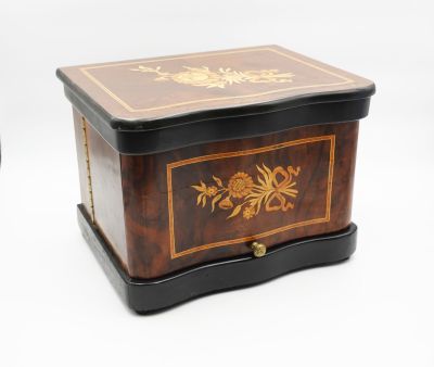 a small wooden box with a floral design on it