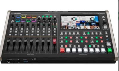 a close up of a digital mixing console with multiple controls