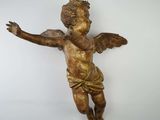 a small statue of an angel hanging from a chain