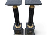 pair of black marble pedestals with gold accents
