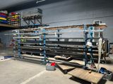 a picture of a room with a lot of shelves and a lot of tools