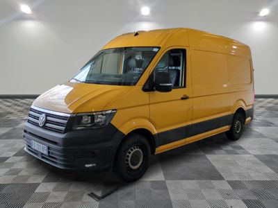 the yellow van is parked on a checkered floor in the garage