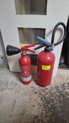 two fire extinguisors sitting next to each other on the floor