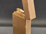 a gold lighter that is sitting on a table