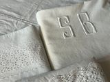 a white table cloth with a monogram on it