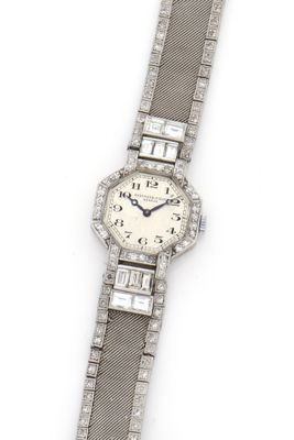 a close up of a watch on a white surface with a white background