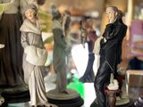 many figurines of people on display in a store