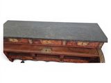 a black marble top on a wooden chest of drawers