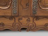 a large wooden cabinet with ornate carvings on it