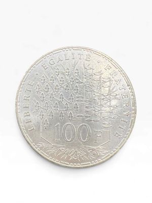 coin on a white surface with a white background and a tree in the center