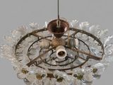 a chandelier made of glass and metal with a candle holder