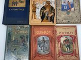 several children ' s books are lined up on a white surface