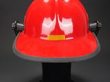 fireman ' s red hard hat on a black background