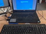 a laptop computer sitting on a desk with a keyboard and mouse