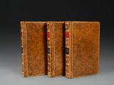 a pair of leather books sitting on top of each other