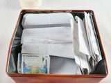 a box with a lot of papers in it on a table