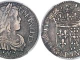 a close up of a coin with a crown on it