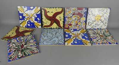 six pieces of colorful tile sitting on top of a table