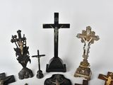 a lot of crosses and other religious items on the table
