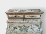 an old painted chest of drawers with birds and flowers on it