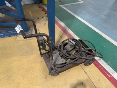an image of a hand truck with a hose attached to it