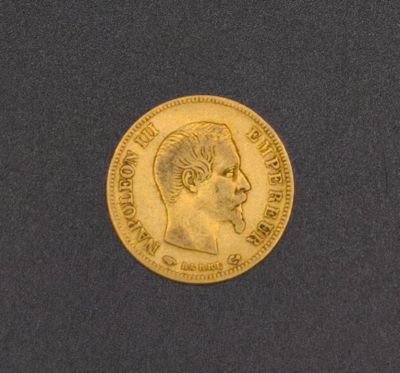 a close up of a gold coin with a man ' s head on it