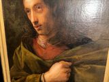 portrait of a man in a green cloak by a painting of a man