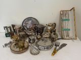 a table with a lot of silver items on it