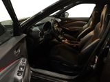 the interior of a car with the door open and the driver ' s seat down