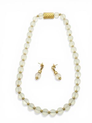 a white beaded necklace and earring set with a gold plated clasp