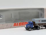a toy truck that is sitting in front of a box