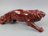 figurine of a red lion on a white background