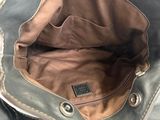 the inside of a brown and black purse with a leather handle