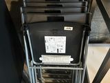 a lot of chairs that are stacked on top of each other