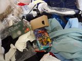 a pile of clothes and other items on a bed