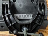an overhead view of a black blower motor on a wooden floor