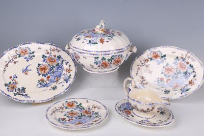 four pieces of china on a table with a cup and saucer