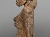 statue of a woman with a basket on her head