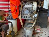 a man standing next to a machine in a garage