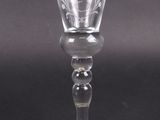 an old fashioned wine glass sitting on top of a black table