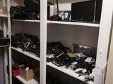 a closet with a lot of electronics on the shelves