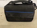 a black bag with a blue line on it sitting on a table