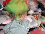 a pile of stuffed animals and toys in a bin